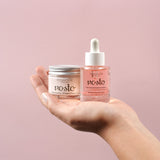 hands holding face elixir and face cream
