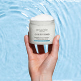 hand holding body scrub bottle